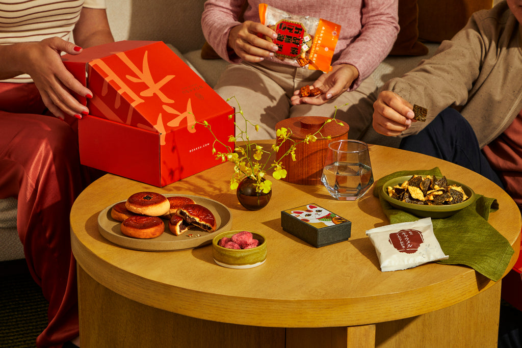 People snacking on Bokksu snacks around a
table