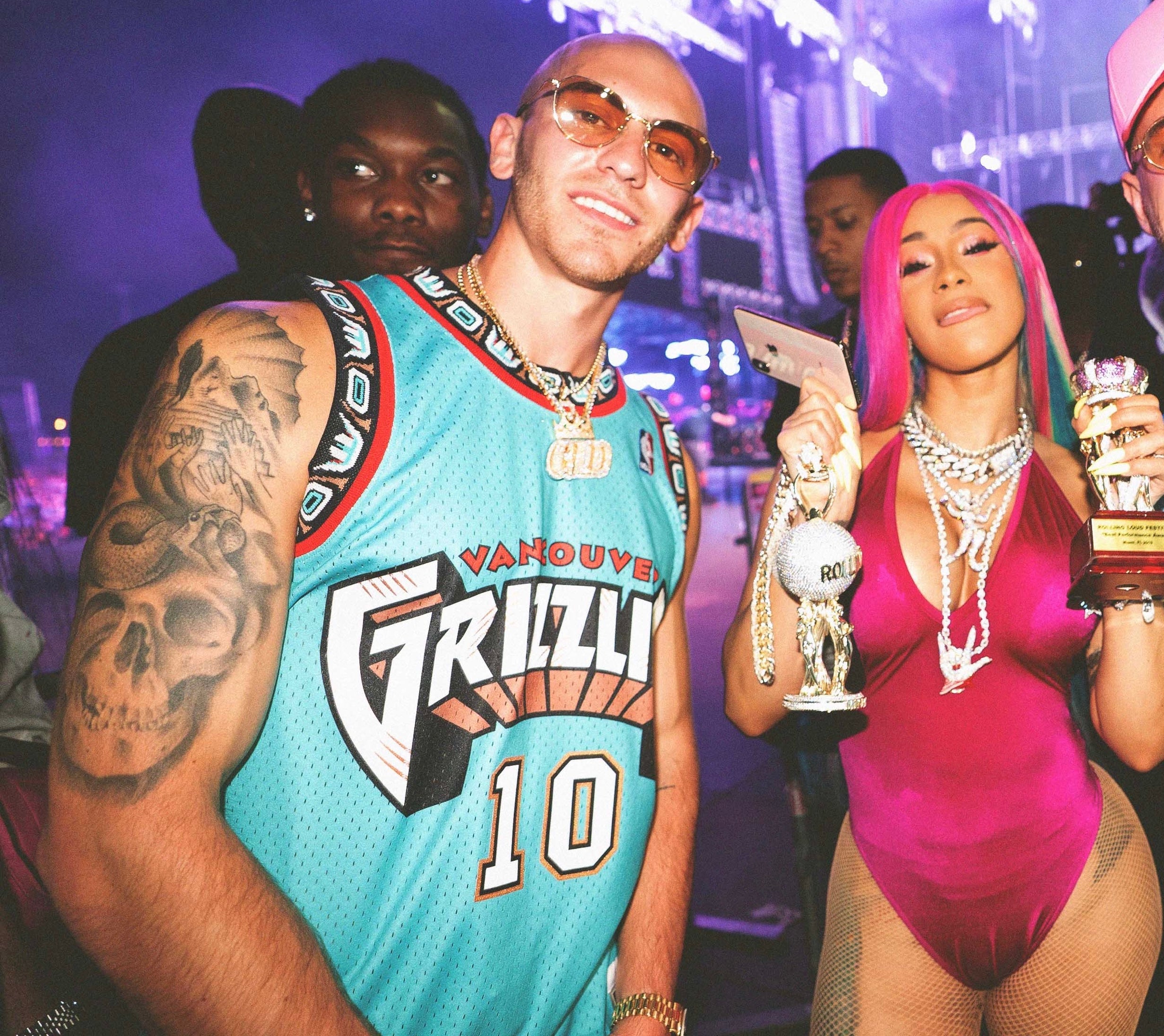 The GLD Shop president and co-founder Christian Johnston posing next to
Cardi B.
